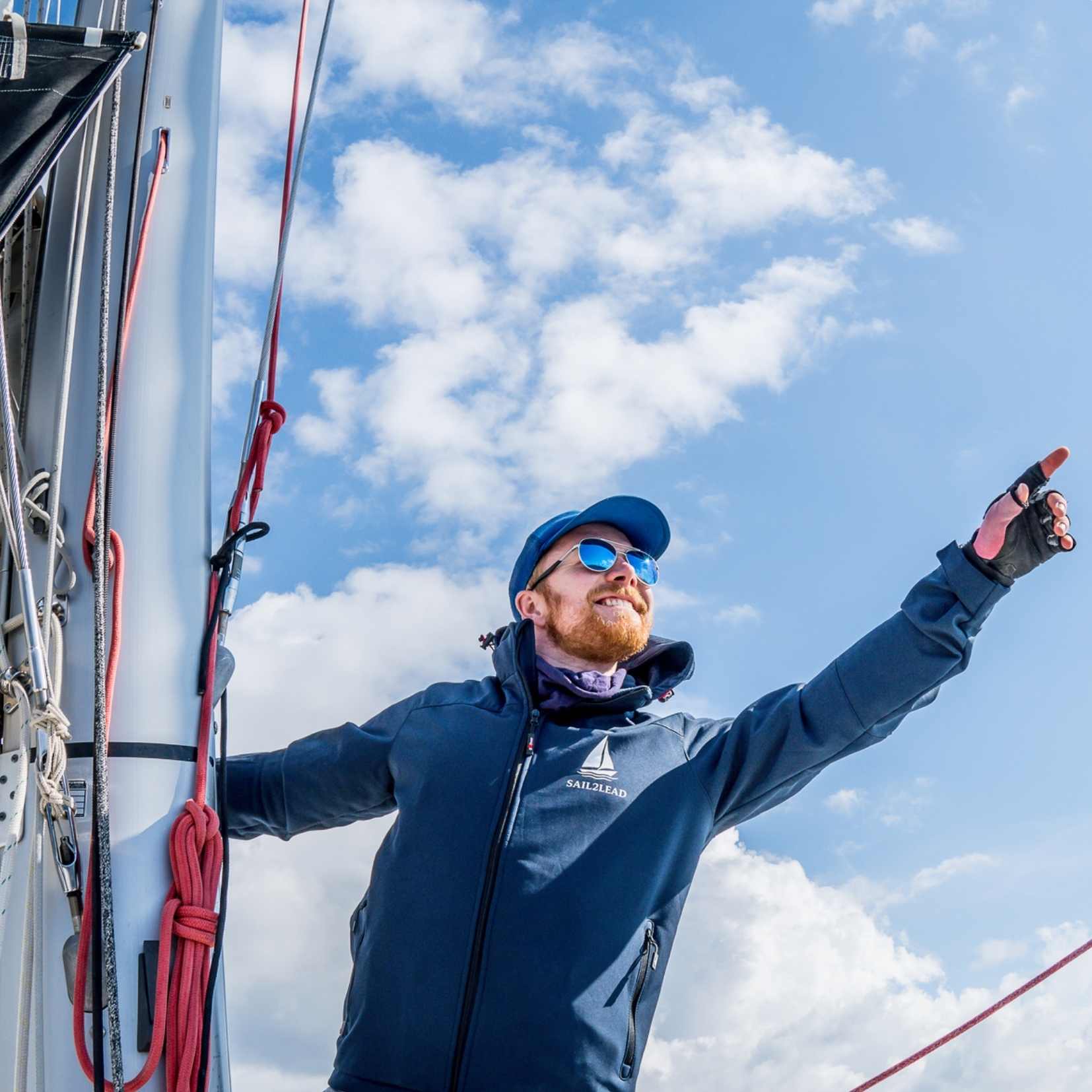 Sail2Lead Coach Andre shows a direction with his index finger